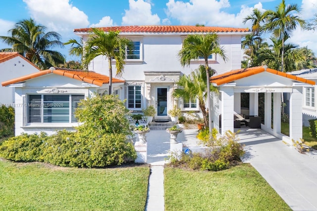 mediterranean / spanish home featuring a front yard