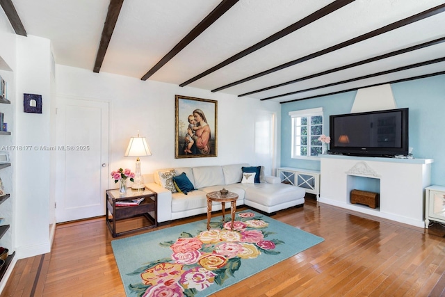 living room featuring beam ceiling and wood-type flooring