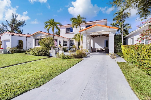 mediterranean / spanish-style home featuring a front lawn