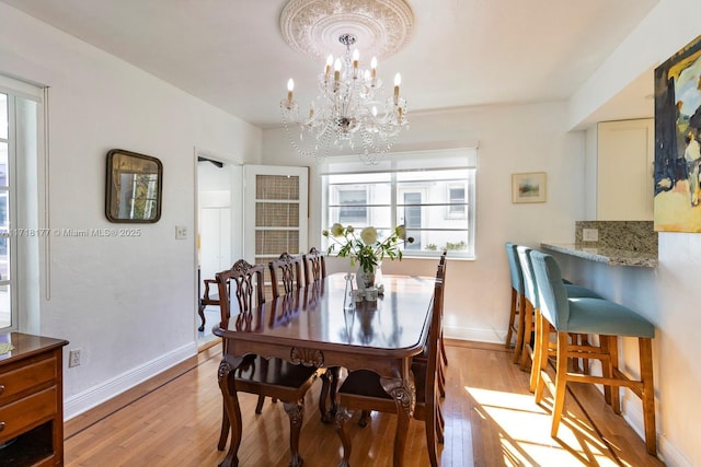 dining room featuring light hardwood / wood-style floors and a notable chandelier