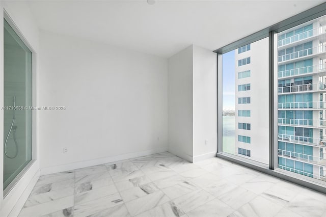 spare room featuring floor to ceiling windows