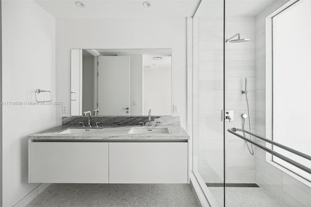 bathroom featuring tile patterned floors, vanity, and a shower with door