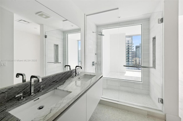 bathroom with vanity, tile patterned floors, and a shower with door