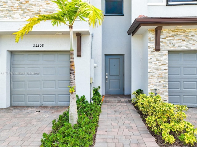 doorway to property featuring a garage