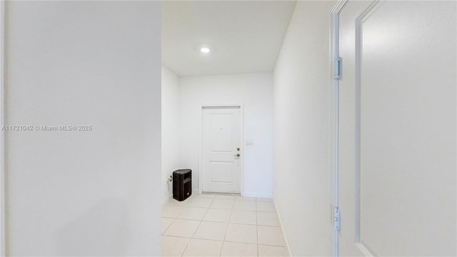 hall featuring light tile patterned flooring