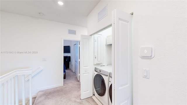 laundry area featuring washer / dryer and light colored carpet