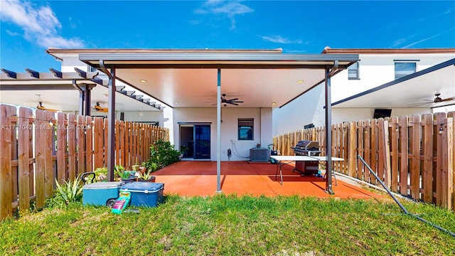 back of property featuring a patio, central AC unit, ceiling fan, and a lawn