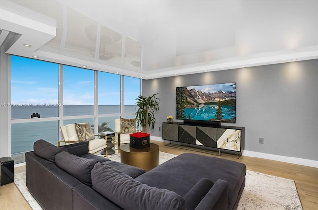 living room featuring a water view and hardwood / wood-style flooring