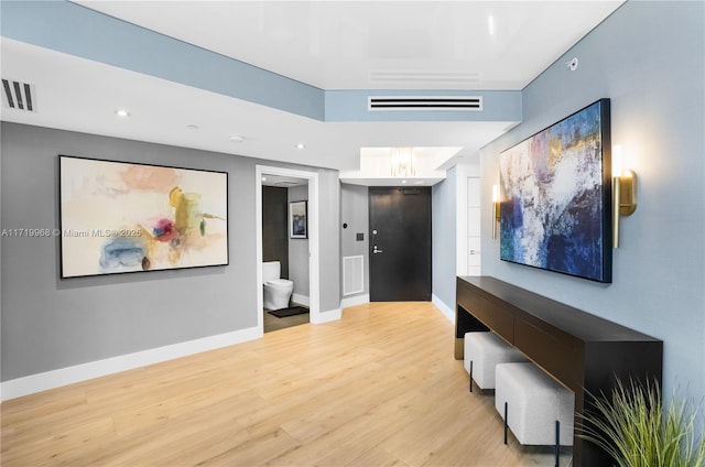 corridor with light hardwood / wood-style floors