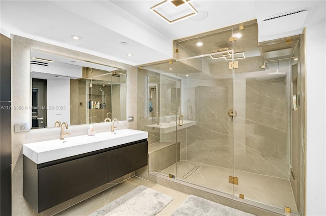 bathroom with tile patterned flooring, vanity, and a shower with shower door