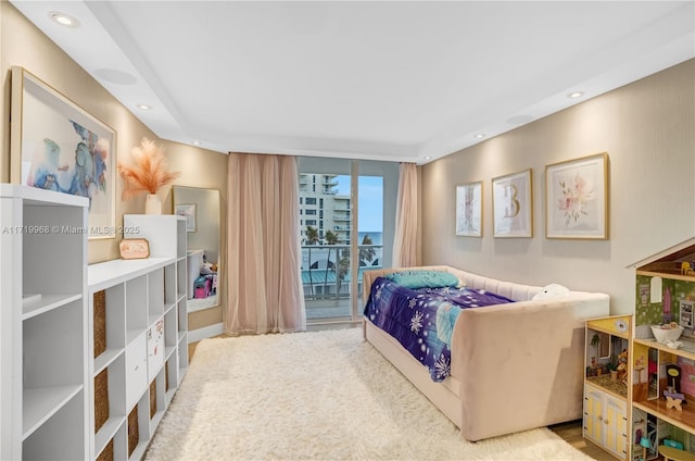 bedroom featuring access to outside and floor to ceiling windows