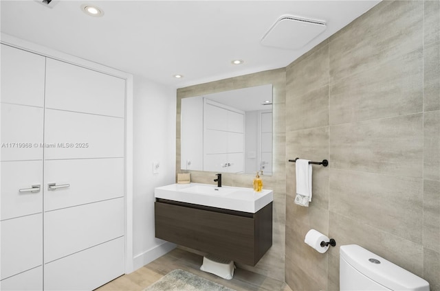 bathroom featuring hardwood / wood-style floors, vanity, and toilet