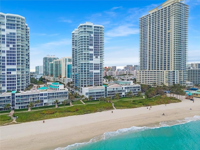 property's view of city with a water view and a beach view