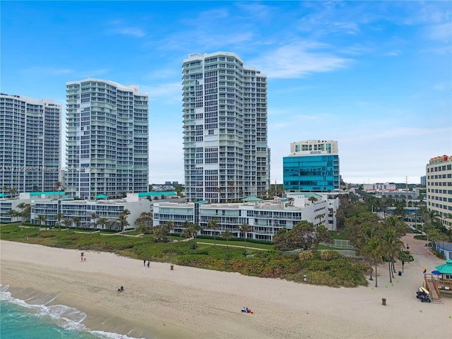 exterior space featuring a water view and a beach view