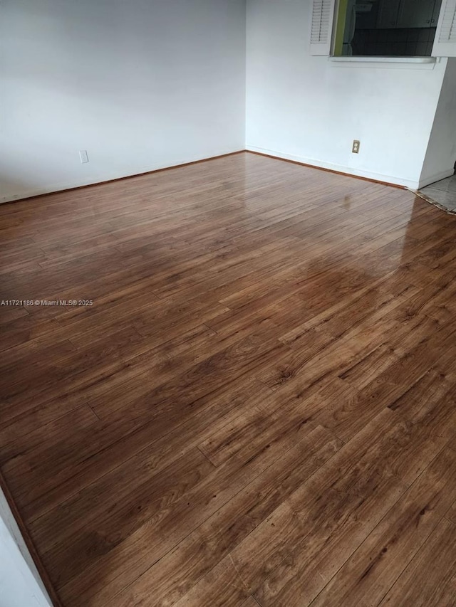 empty room featuring dark wood-type flooring