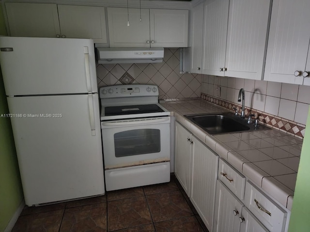 kitchen with white cabinets, white appliances, and tile countertops