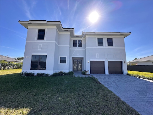 view of front of property with french doors, a front lawn, and a garage