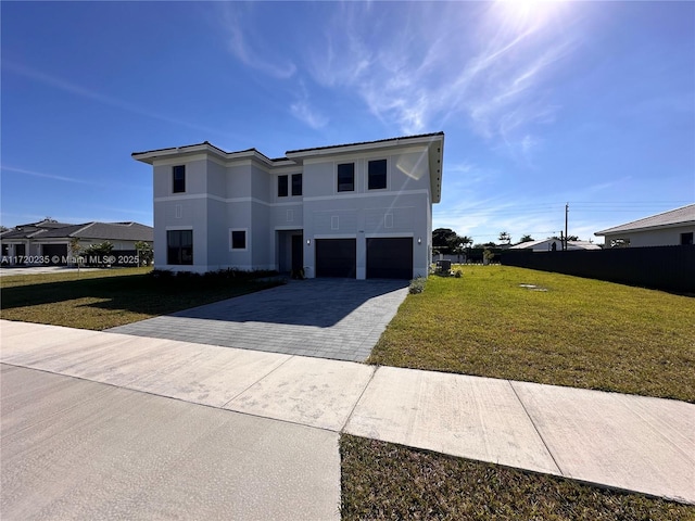 view of front of property featuring a front yard and a garage