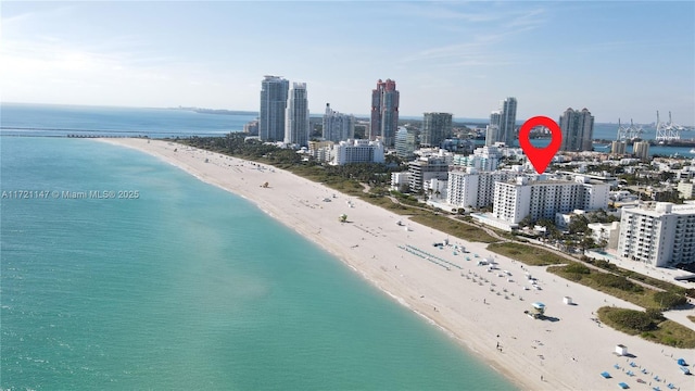 bird's eye view with a water view, a city view, and a view of the beach