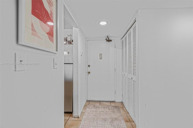 corridor featuring light tile patterned floors