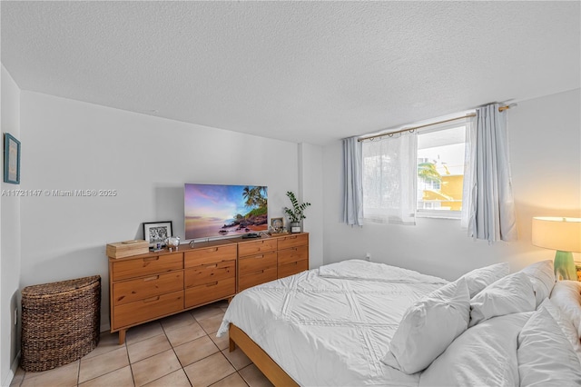 tiled bedroom with a textured ceiling