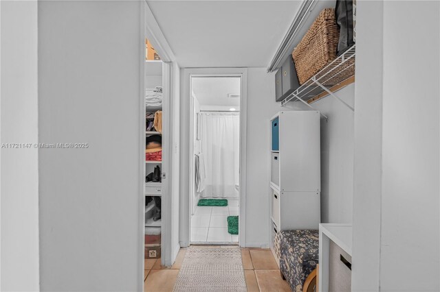 walk in closet featuring light tile patterned flooring