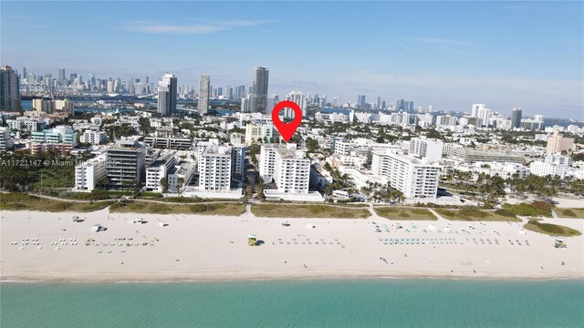 bird's eye view with a water view and a beach view