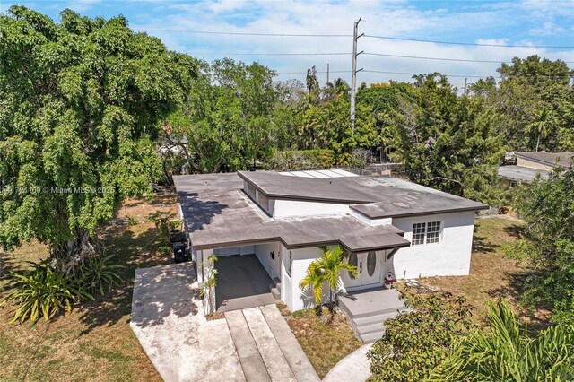 571 Raven Ave, Miami Springs, FL 33166 - view of front of property with concrete driveway, stucco siding, and an attached carport