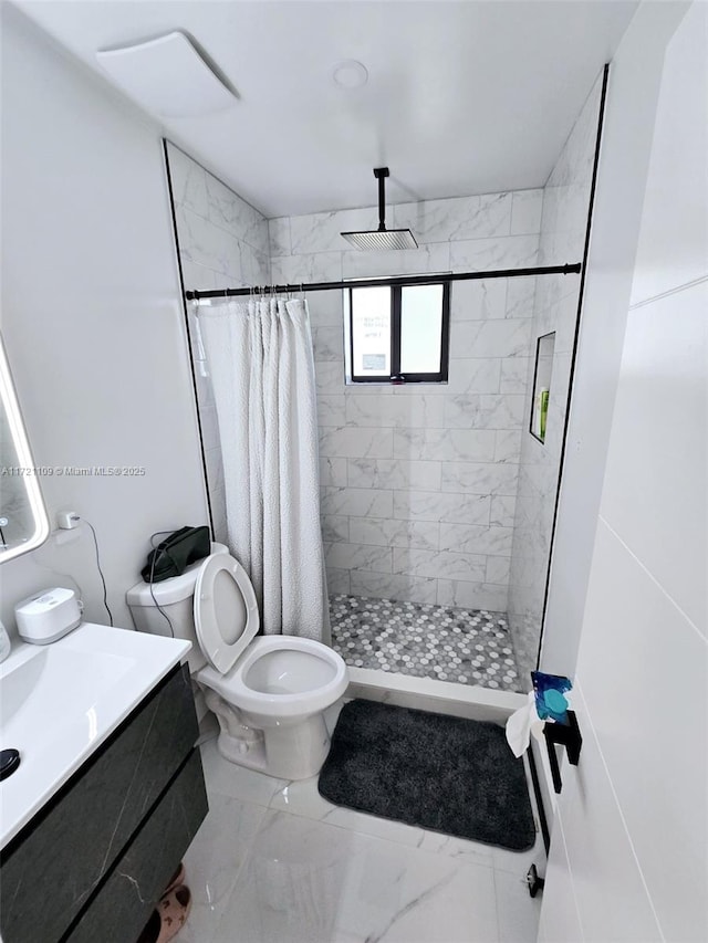 bathroom featuring toilet, a shower with shower curtain, and vanity