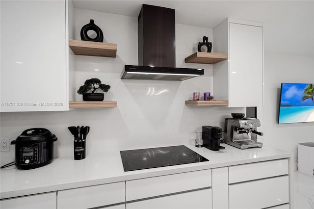 571 Raven Ave, Miami Springs, FL 33166 - kitchen featuring island exhaust hood, black electric cooktop, open shelves, and white cabinetry