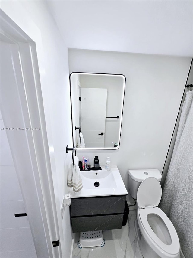 bathroom featuring toilet and vanity