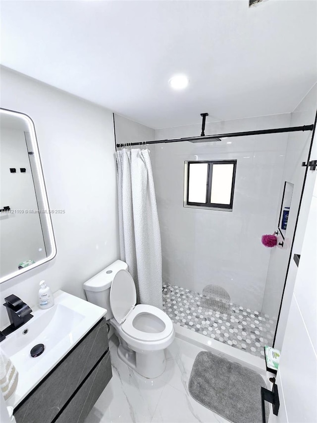 bathroom featuring toilet, a shower with shower curtain, and vanity