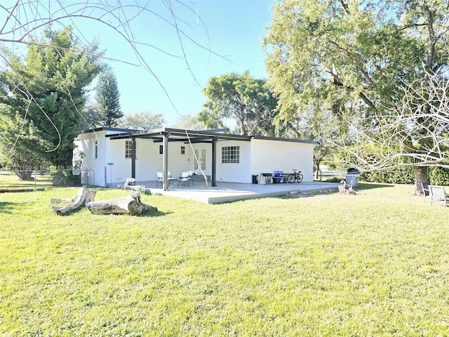 rear view of house with a yard