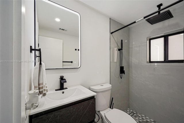 571 Raven Ave, Miami Springs, FL 33166 - bathroom with toilet, visible vents, tiled shower, and vanity