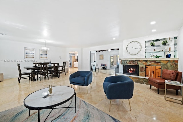 living room with a stone fireplace