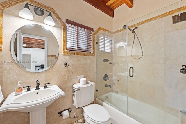 full bathroom featuring beam ceiling, enclosed tub / shower combo, toilet, decorative backsplash, and tile walls