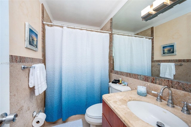 bathroom with vanity, toilet, tile walls, and crown molding