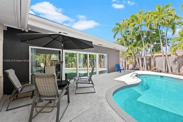 view of swimming pool with a patio area