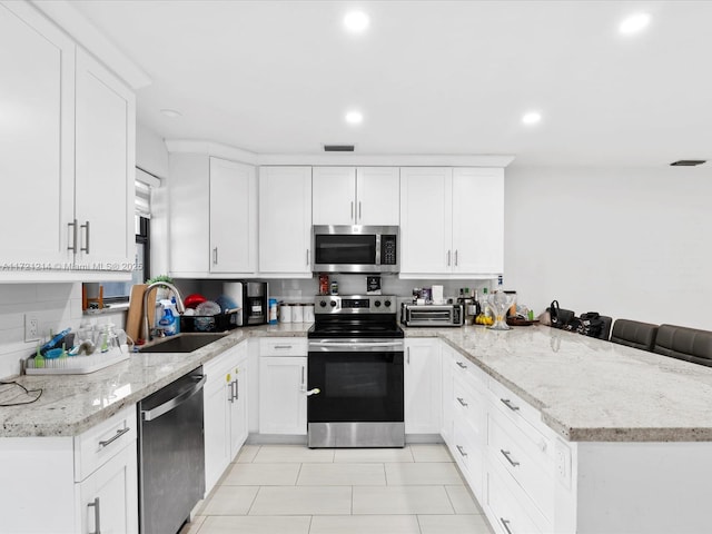 kitchen featuring sink, white cabinetry, and stainless steel appliances