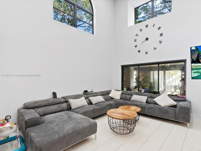 living room featuring a wealth of natural light and a high ceiling