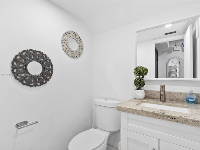 bathroom with vanity and toilet