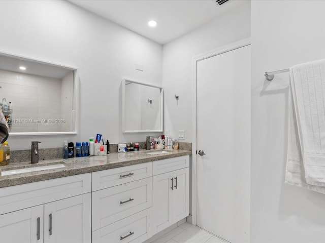 bathroom with tile patterned flooring and vanity