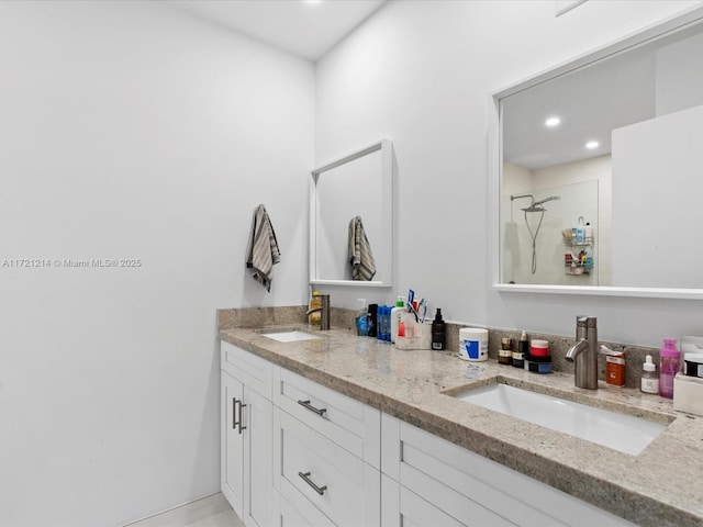 bathroom featuring a shower and vanity