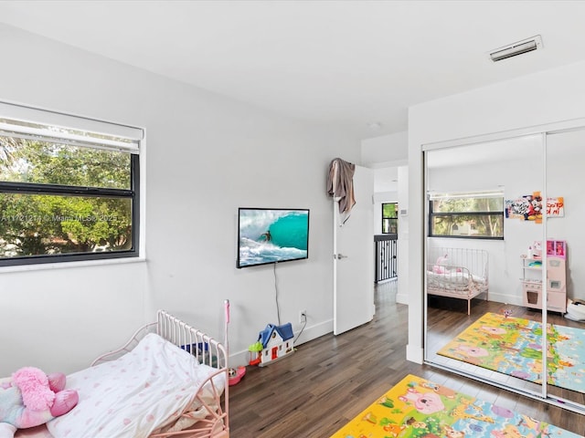 bedroom with dark wood-type flooring