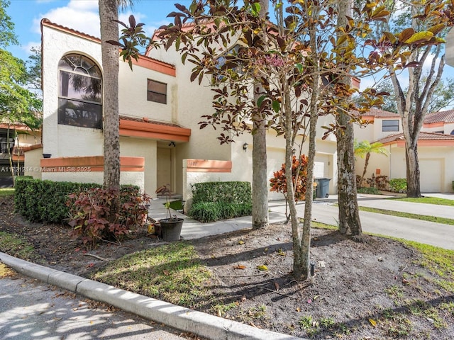 mediterranean / spanish-style home featuring a garage