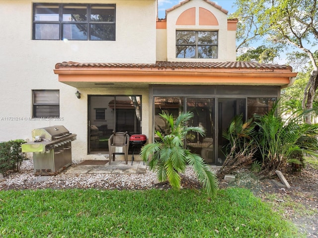 rear view of property with a sunroom