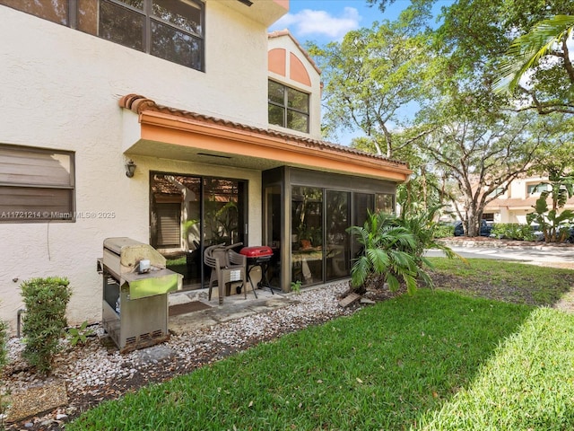 back of house with a lawn