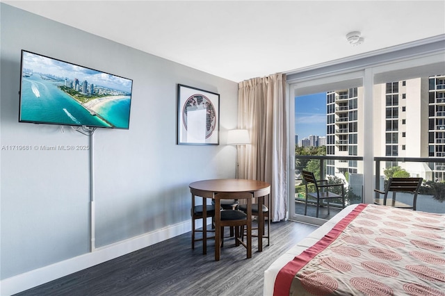 bedroom with access to exterior and hardwood / wood-style flooring