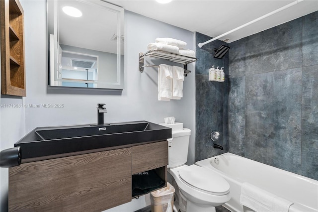 full bathroom featuring toilet, vanity, and tiled shower / bath