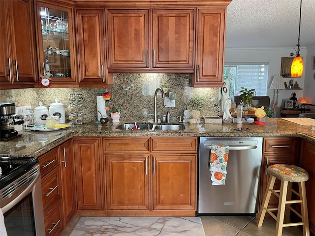 kitchen featuring decorative backsplash, dark stone countertops, sink, and appliances with stainless steel finishes